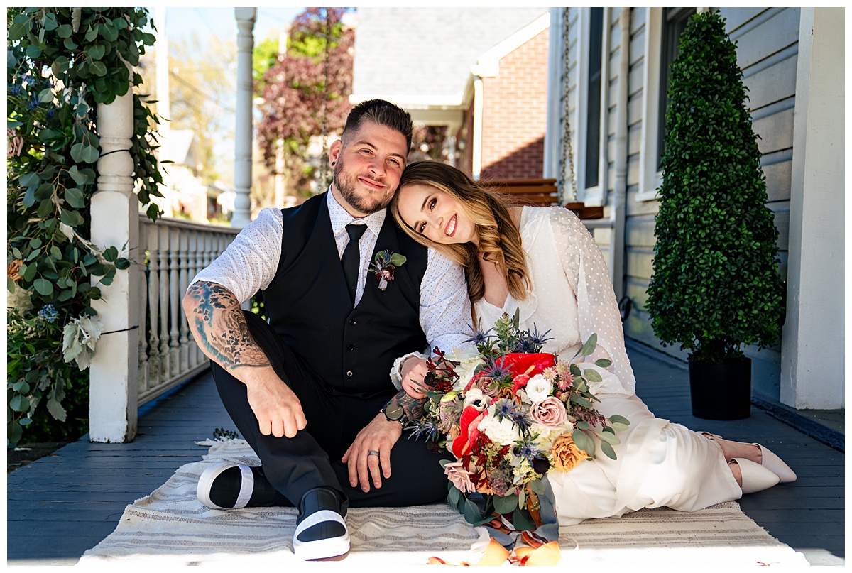 A couple poses for a photojournalistic wedding portrait on their wedding day.