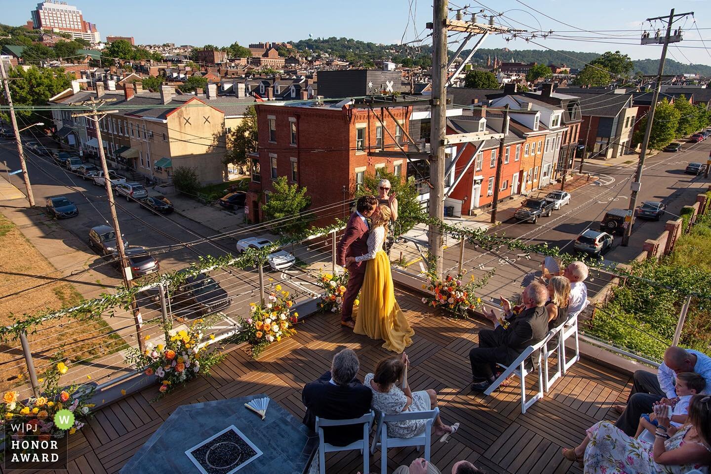 Grateful for another Honor Award given by the Wedding Photojournalist Association❤️ Normally I like to get close for the first kiss, but for Tamara and Tienne&rsquo;s first kiss, I took a gamble and climbed on to their upper roof. My risk paid off as I captured not only the trendy Lawrenceville neighborhood, but my favorite detail is catching the unplanned moment in the bottom right corner with the bride&rsquo;s brother-in-law and nephew having their own special moment.